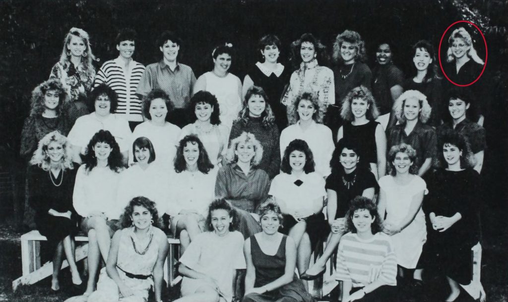 Women from the Durian House pose together. The ladies are dressed up and smiling.