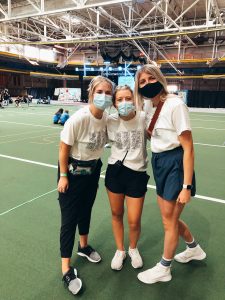 Three young ladies pose together inside of Lied Rec center on the Iowa State University campus.