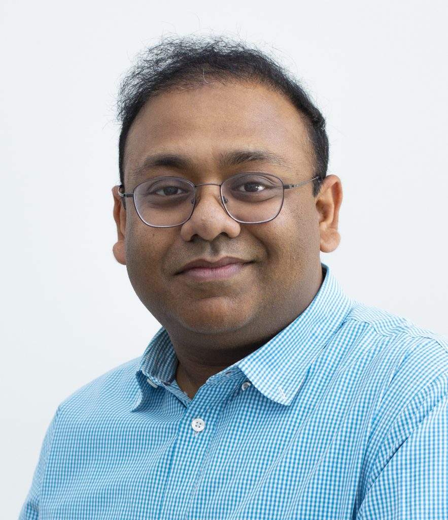 A mechanical engineering professor wearing a blue collared shirt