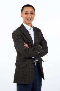 Photo of Hongwei Zhang standing and smiling