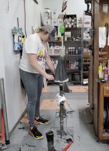 Mechanical engineering student Jillian Dunn works in a workshop making a prosthetic leg.