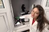 Anwesha Sarkar in a lab coat and glasses, working with a microscope in a lab setting