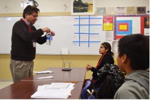 Cornelius standing and presenting to students