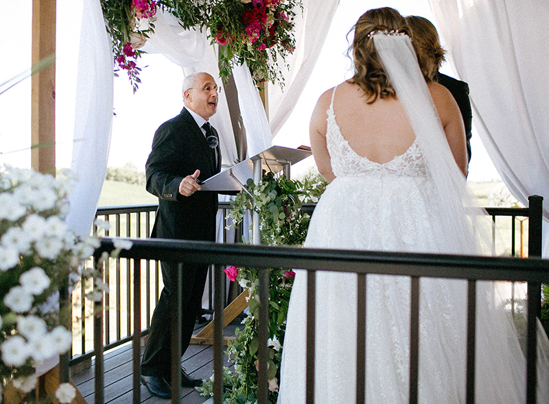 Teaching professor Alan Constant welcomes family and friends to the August wedding of high school sweethearts Jonathan Zaugg and Sara Medina.