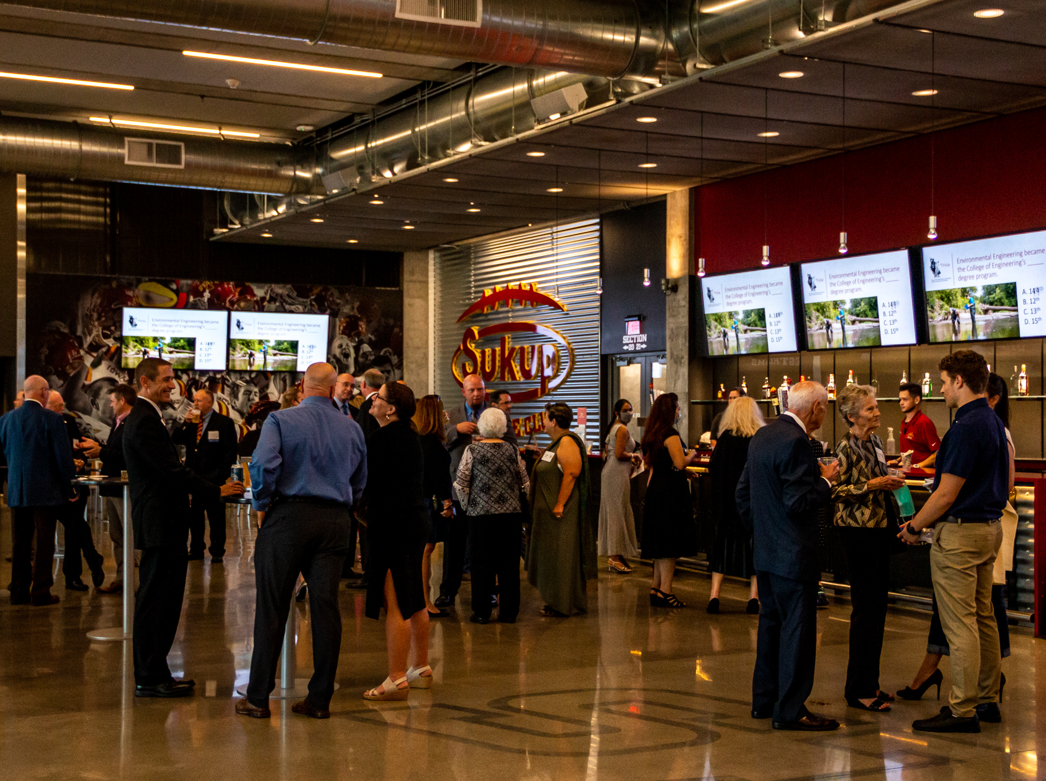 Attendees enjoy drinks and listen to jazz music at the Sukup Endzone Club.