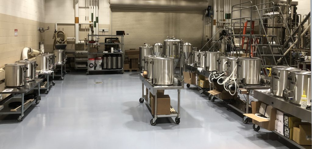 Beer brewing equipment is set up inside a large room