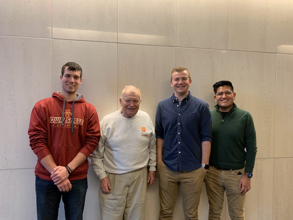 A photo of four men posing for the camera.