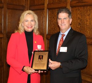 Lori Ryerkerk is presented with her CBE Hall of Fame plaque by department chair Andy Hillier