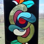 A stained glass artwork. This piece includes most of the colors from the rainbow.