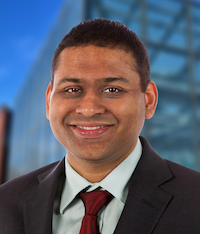 Headshot of mechanical engineering associate professor Adarsh Krishnamurthy. He is wearing a suit and a red tie.