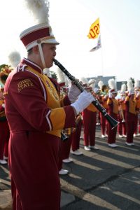 Grant Barton plays his clarinet wearing ISU marching band uniform