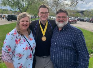 Grant Barton poses with his parents, Tracy and Carl, on the day of his graduation in 2019
