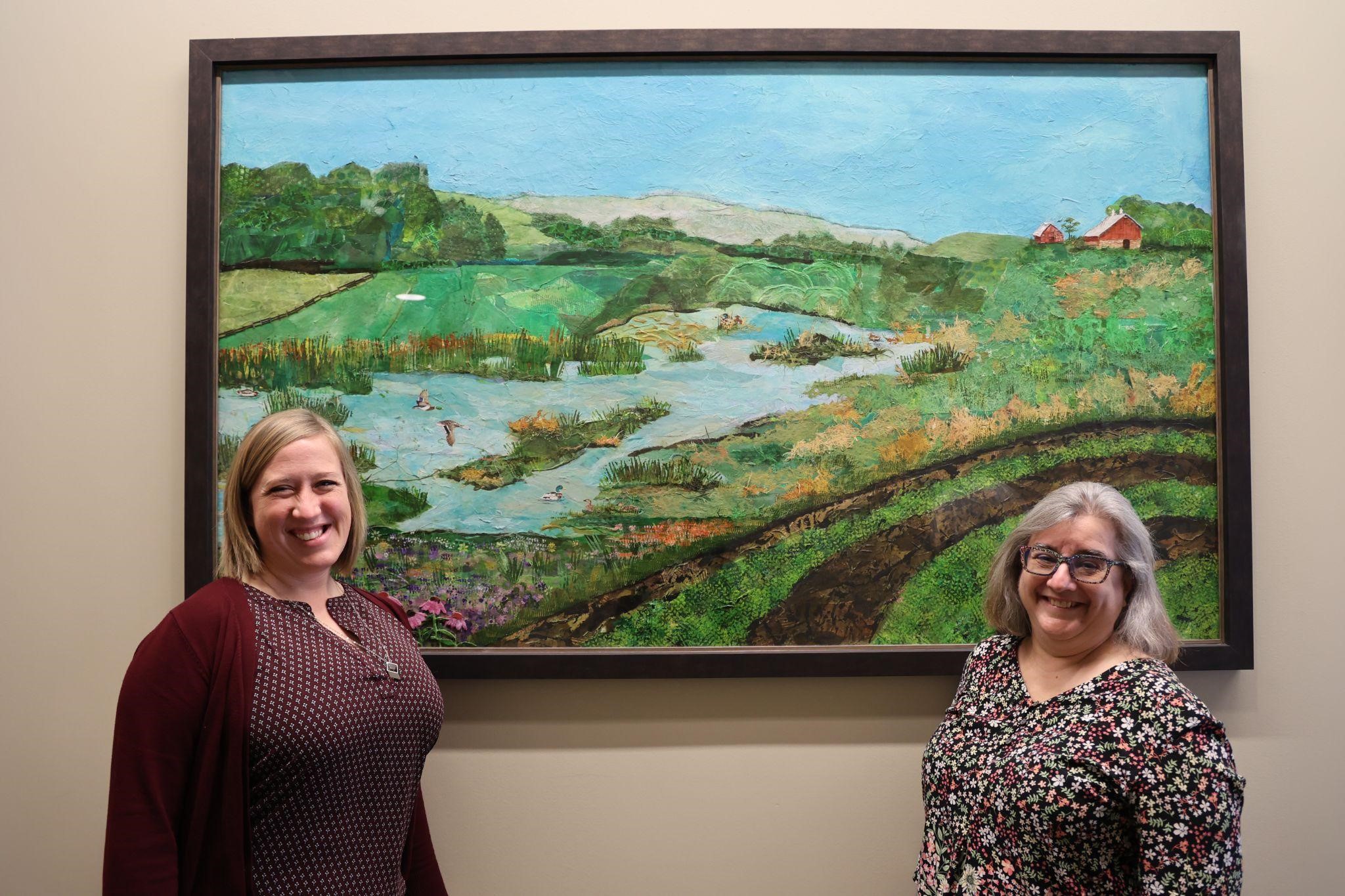 From left to right: Ann Staudt and Cecelia Comito with wetlands artwork