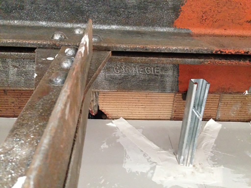 The text "CARNEGIE" can be seen stenciled on this steel beam. 
