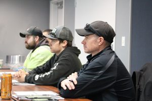 Photo of three individuals learning about safety training