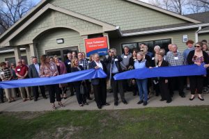 Photo of Tollakson and Camp Sunnyside cutting the ribbon to the new Rick Tollakson Wellness Center