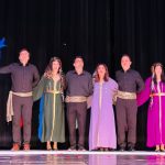 A group stands on stage during the Norooz event