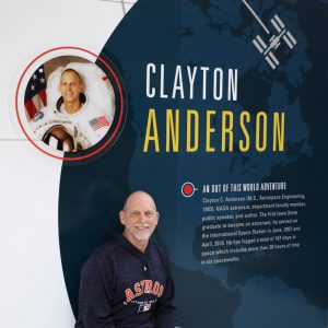 Anderson next to his commemorative wall graphic in Howe Hall