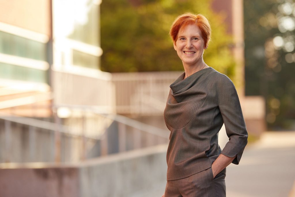 Caroline Hayes smiles and poses for the camera outside of Black Engineering Building