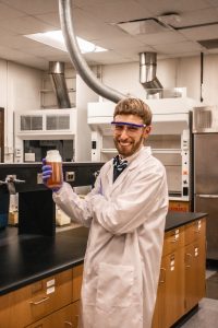 Joe Charbonnet holds a sample of concentrated fire-fighting foam. This foam includes many PFAS, likely including undiscovered compounds in need of confident identification.