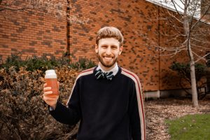 Charbonnet outside of Town Engineering posed with a bottle of PFAS