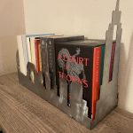 A metal city skyline holding books
