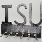 A metal coat rack with the letter ISU