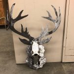 A metal rendition of a mounted deer head