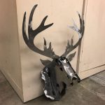 A metal rendition of a mounted deer head