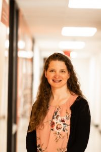 Photo of Cassie standing in hallway