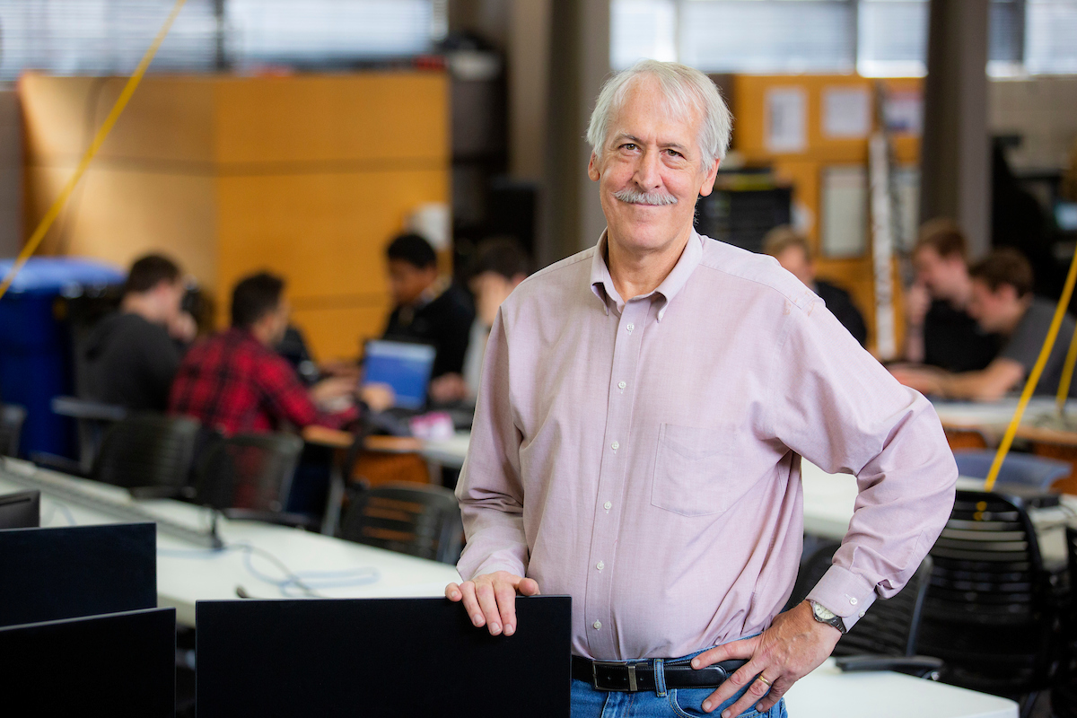 Instructor stands in computer classroom