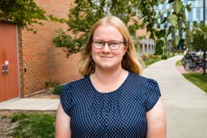 Headshot of Carey standing outside of ABE's building, Sukup Hall