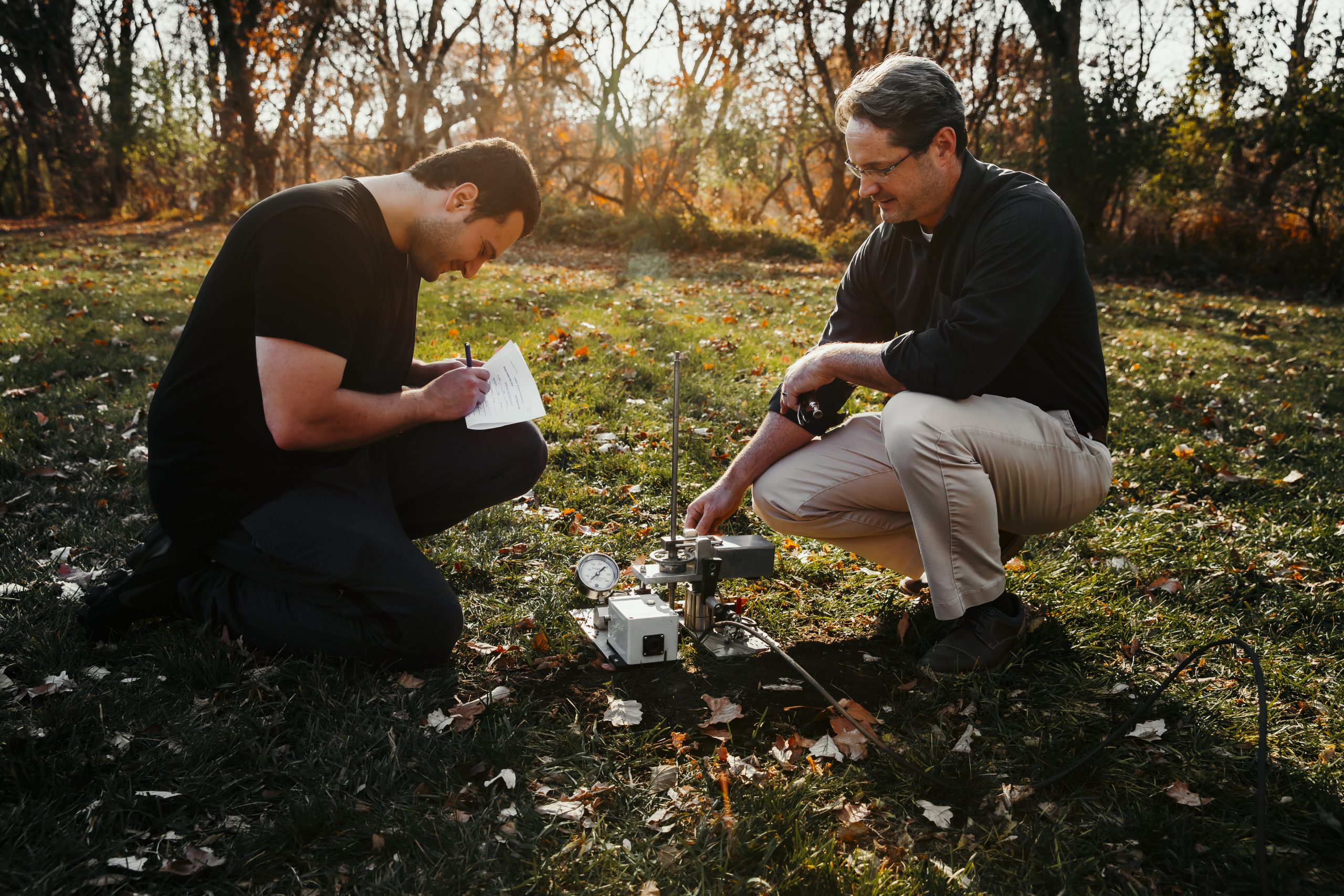 Photo of Ashlock and a student collecting data from the device