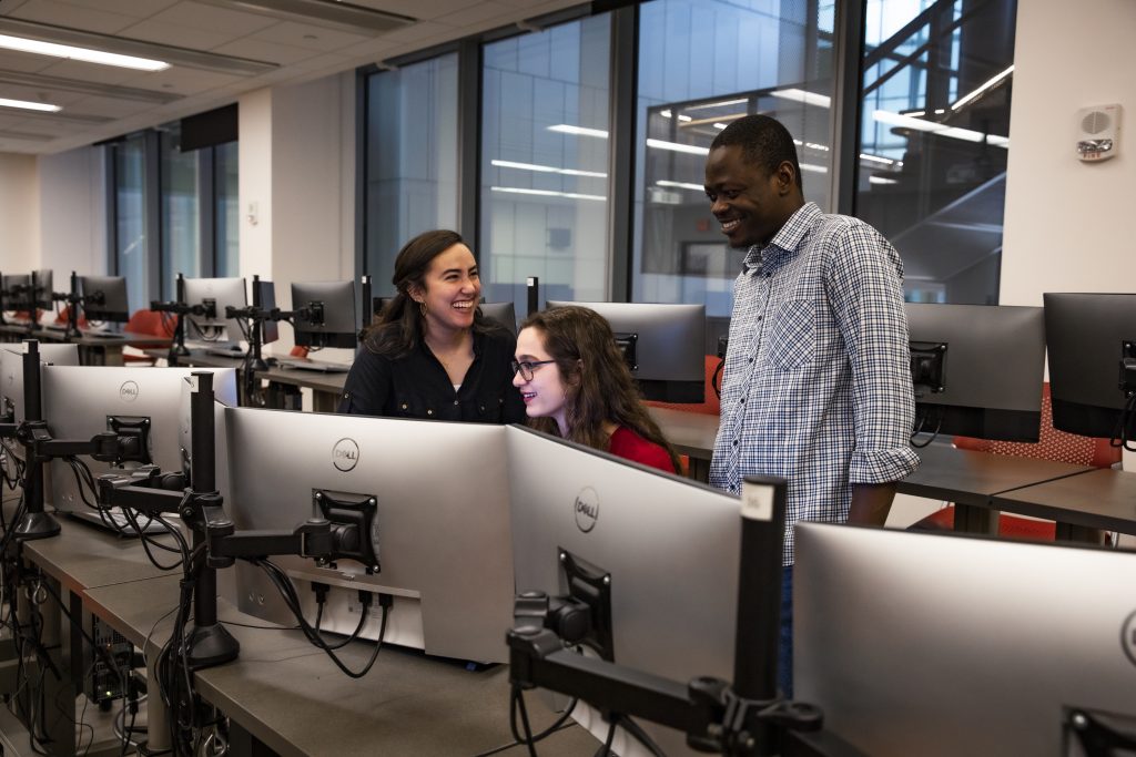 Photo of three ABE students discussing the dashboard project