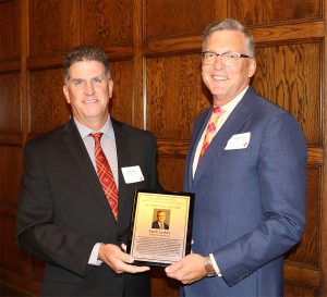 CBE chair Andy Hillier presents the Hall of Fame plaque to Mark Lashier