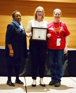 Student chapter president Hailey Bates and faculty mentor Stephanie Loveland display Outstanding Student Chapter of the Year award with AIChE president Christine Grant