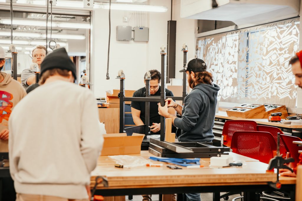 students working in the lab with Hory to build the equipment