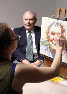 Burnet posing for artist Rose Frantzen for his Faces of Iowa State painting