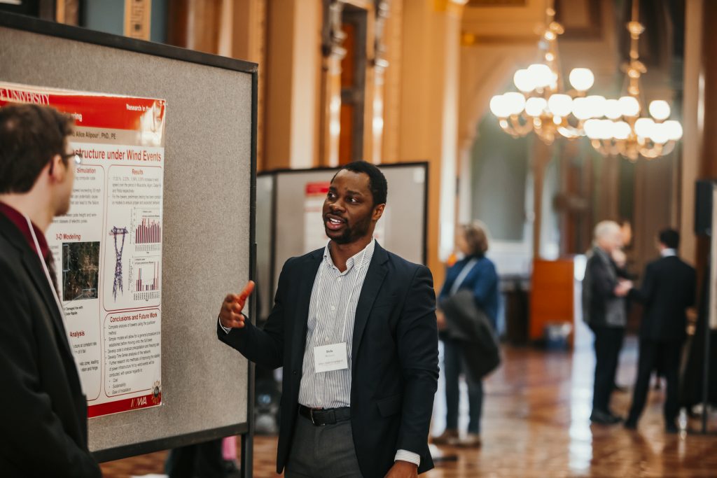 Dela presenting his research at the capitol
