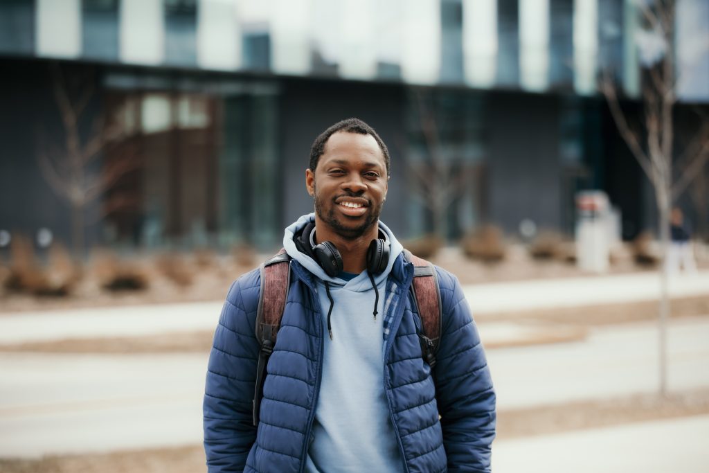 Dela standing outside of the student innovation center