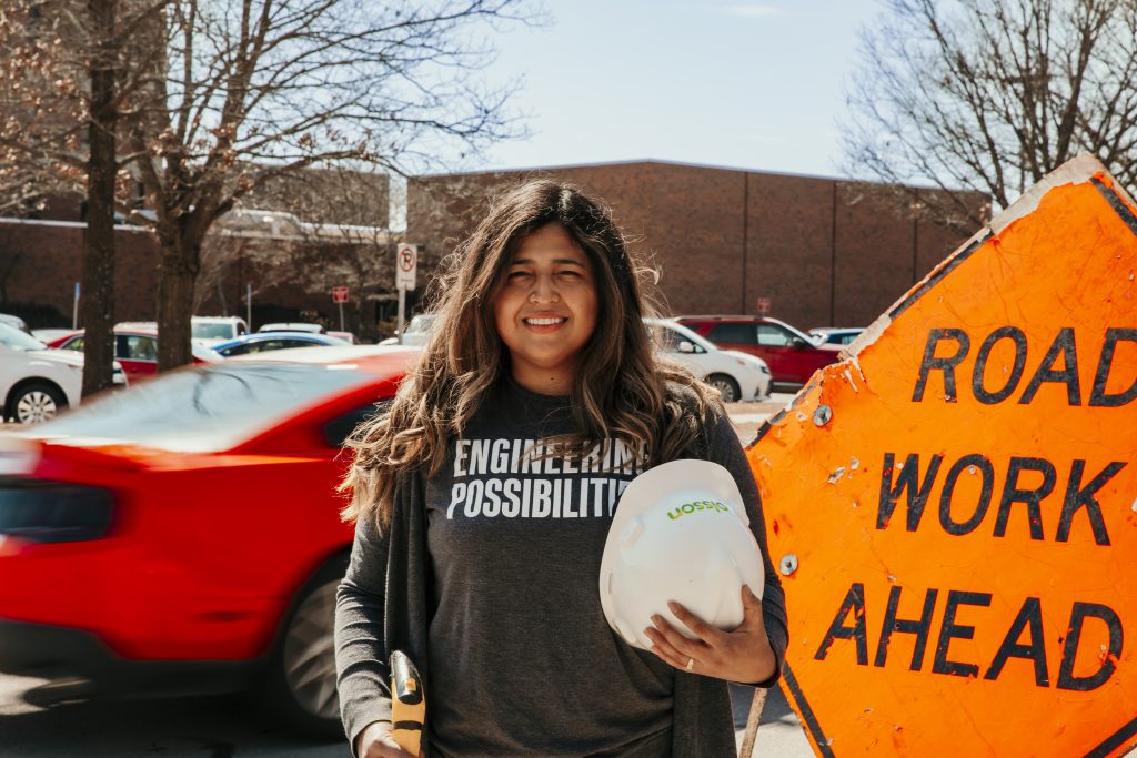 Sosa holding hard hat in front of Town Engineering 