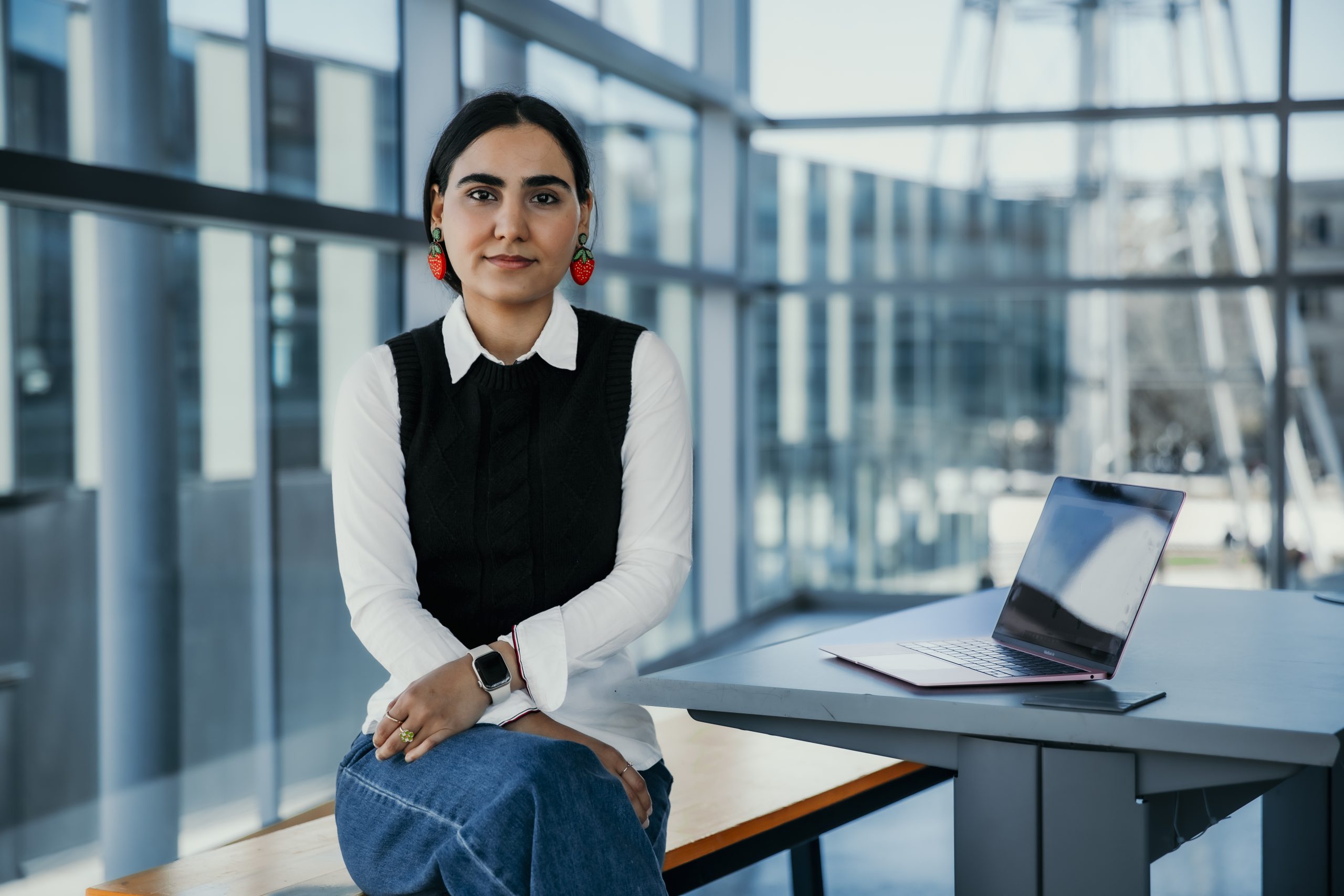 Ganji sitting at a desk with her laptop