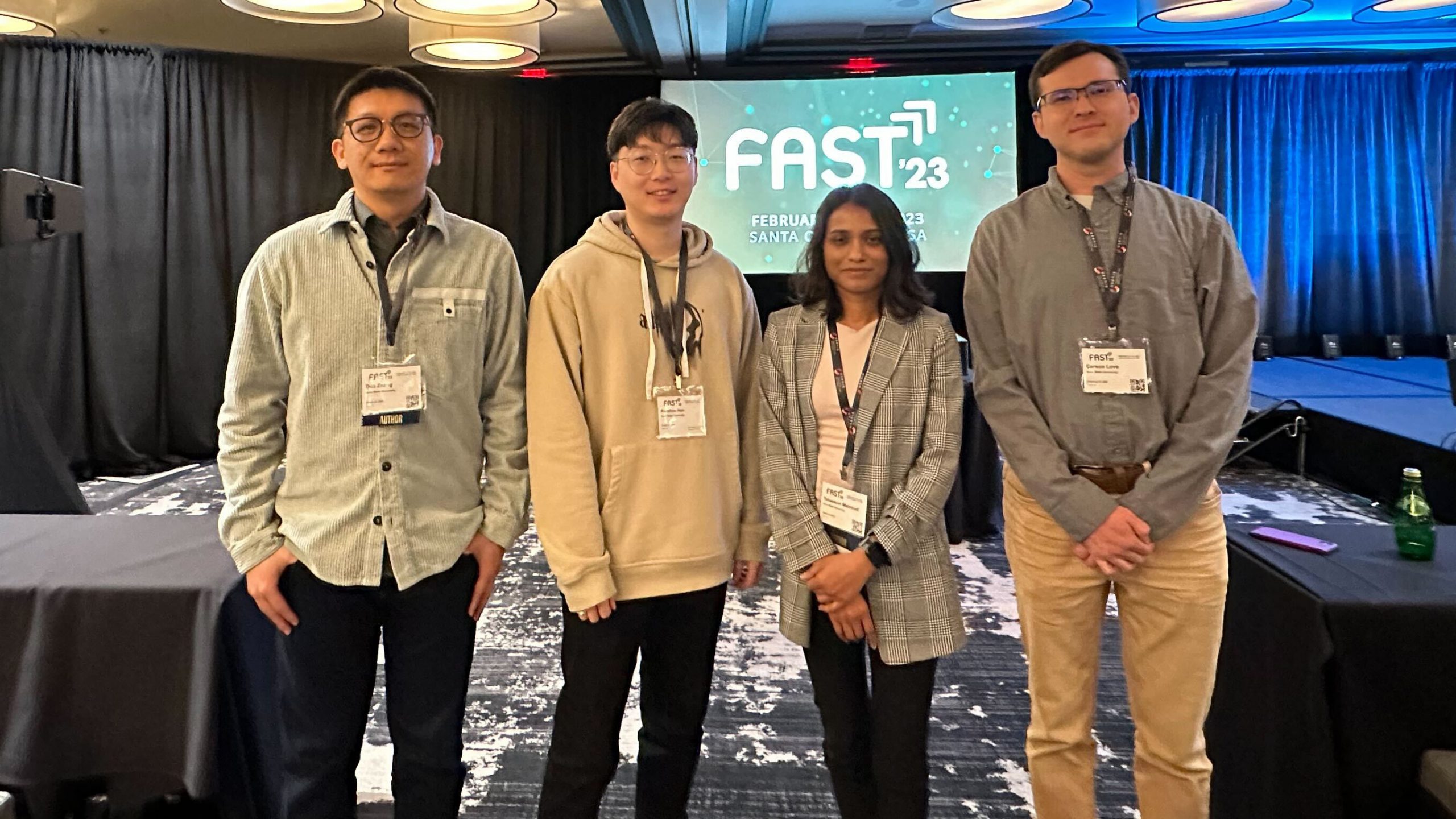 Duo Zhang, Runzhou Han, Tabassum, Carson Love from left to right standing in front of screen with FAST'23 on it.