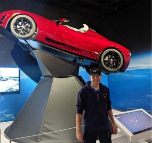 Zach Luppen with replica of Tesla roadster launched into Earth orbit by SpaceX in 2018.