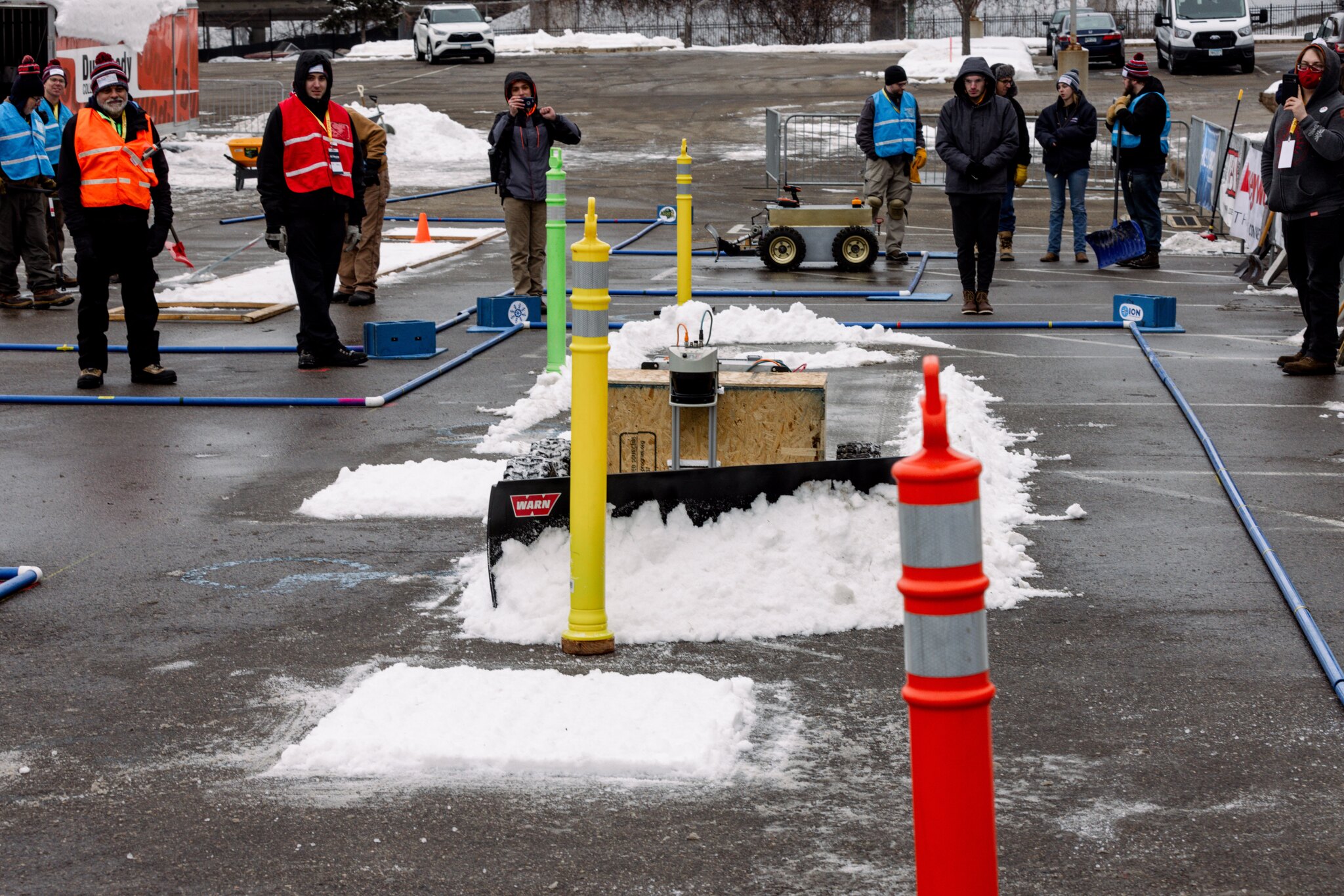 Robotic snowplow pushing snow autonomously.