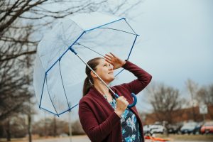 Poleacovschi holding an umbrella in the rain