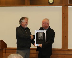 Department Chair Alric Rothmayer awarding Rick Rezabek with plaque