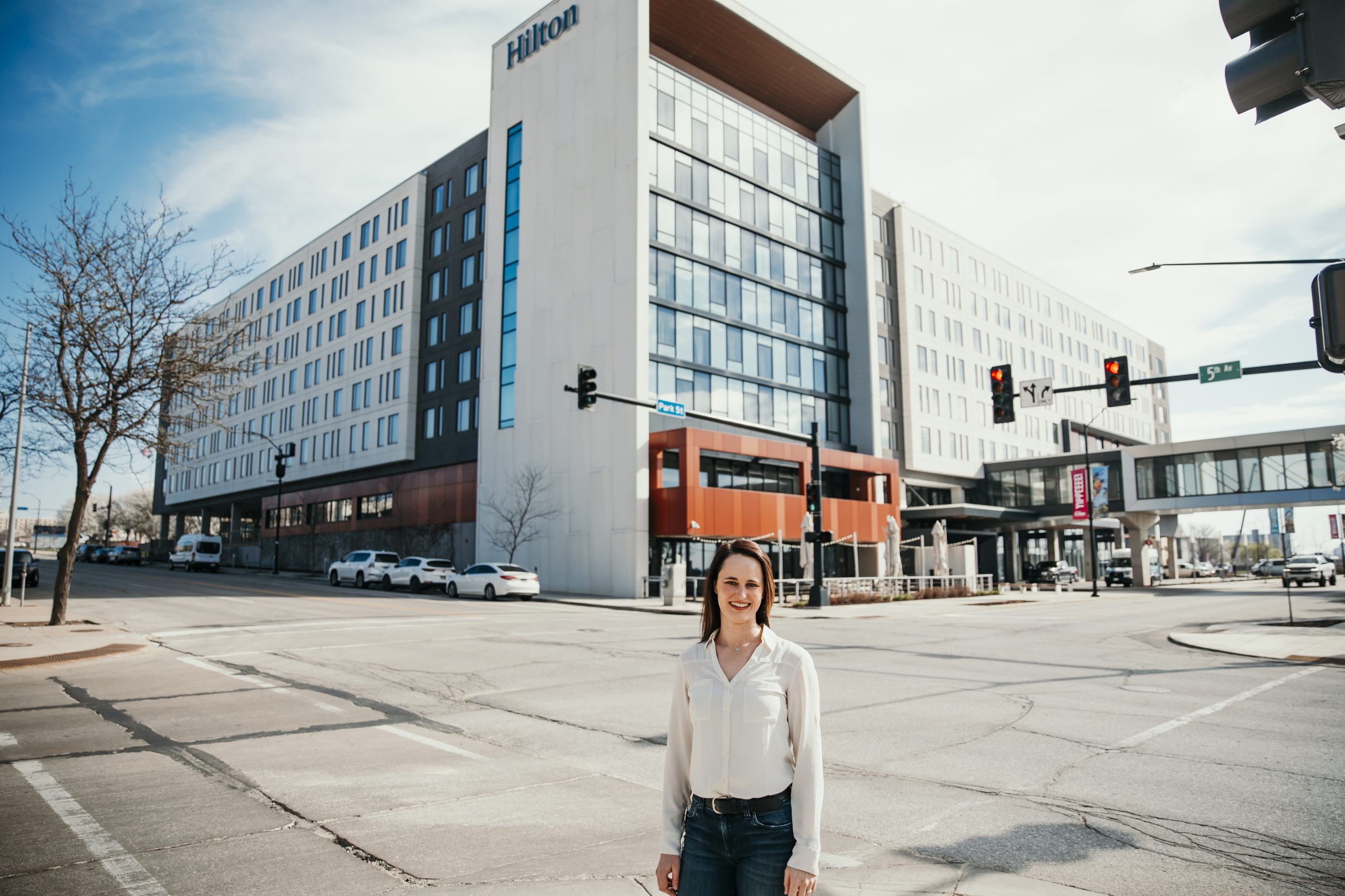 Herrera standing in front of the Hilton Des Moines Downtown Hotel