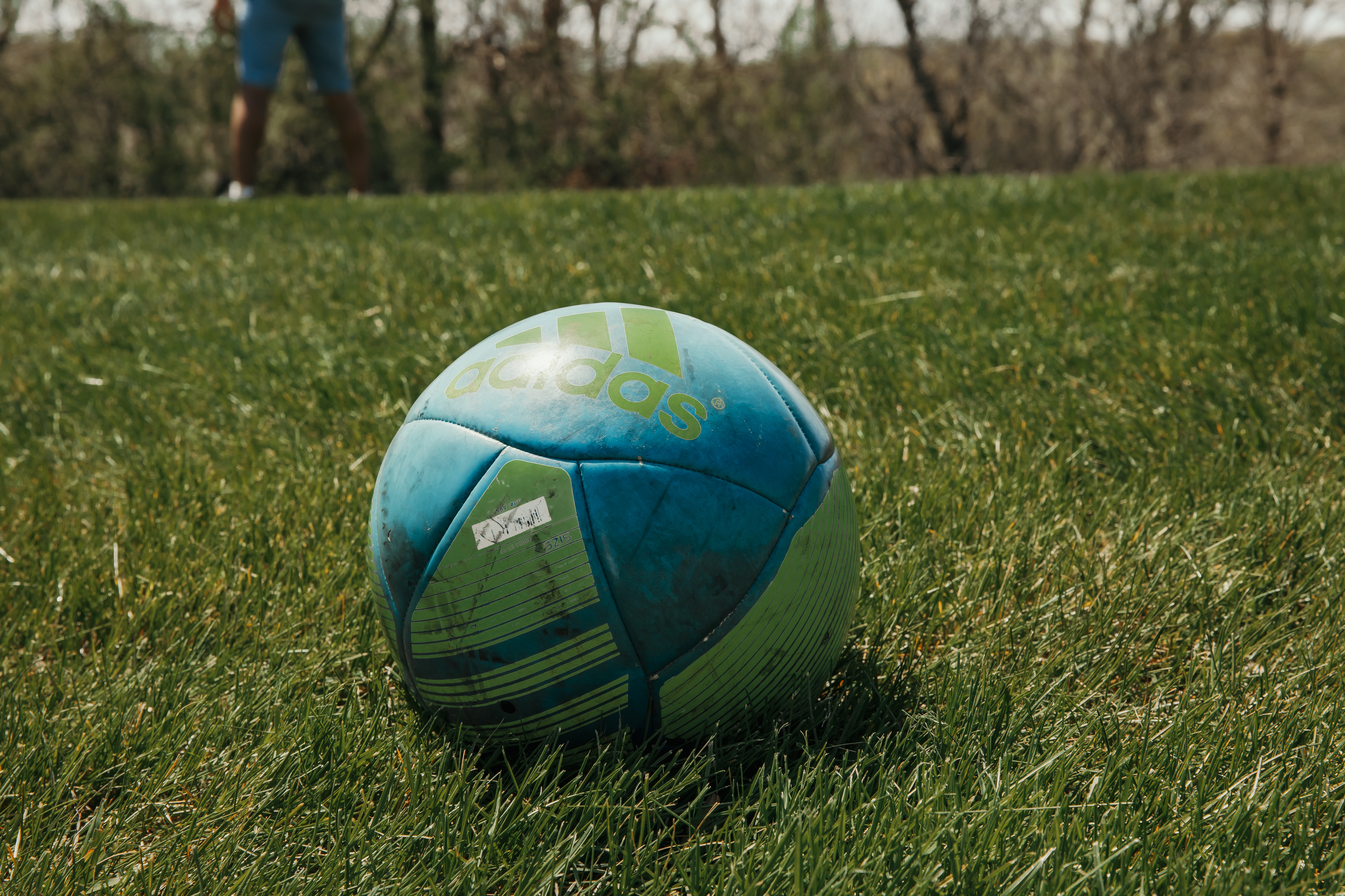 Soccer ball sitting still on the field 