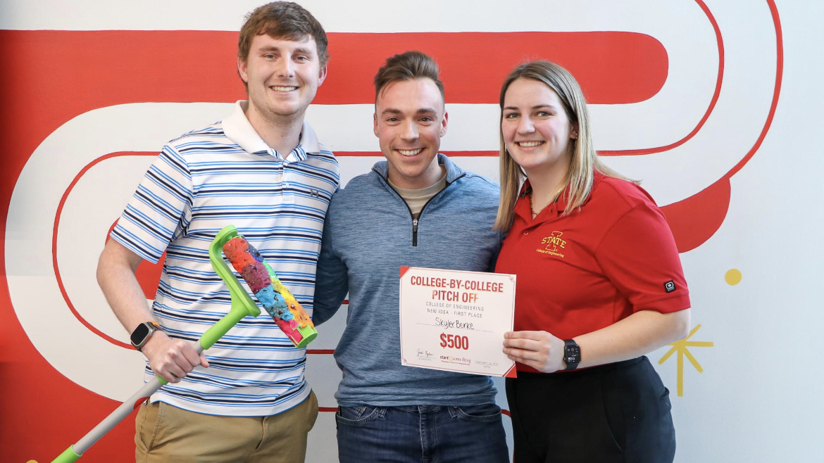 Skyler Burke, judge Nick Herrig (’17 industrial engineering), and Paige Wogahn pose with their winning product, the Safety Roller.